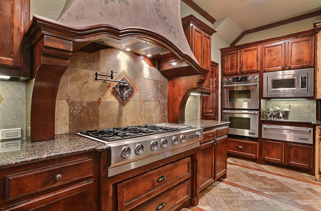 Granite kitchen countertop and island in an Asheville home with a stone backsplash